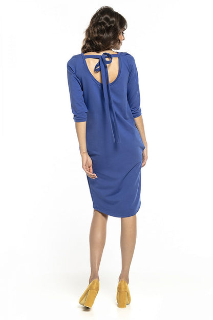 Back view of a luxurious blue tuba dress with a charming tie detail at the neckline, featuring 3/4 sleeves, crafted by Tessita.