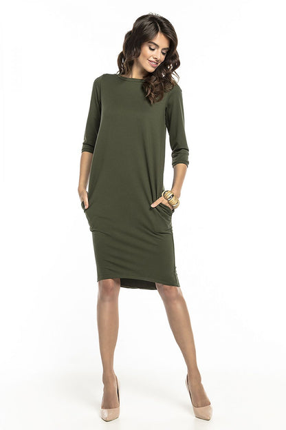 Chic loose-fitting tuba dress in rich olive green with 3/4 sleeves and practical side pockets, designed by Tessita, perfect for versatile styling.