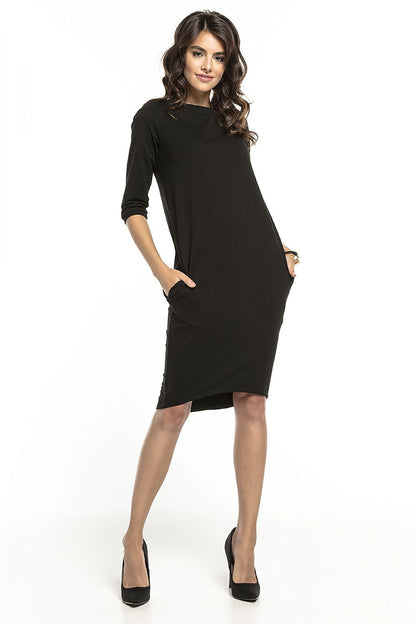 Elegantly styled loose-fitting black tuba dress with 3/4 sleeves and pockets, designed by Tessita, showcasing a sophisticated look for casual or formal occasions.