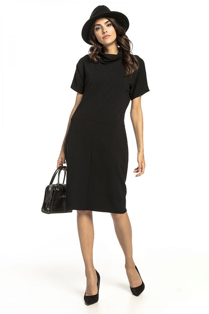 Elegant loose-fitting black knitted sweatshirt dress by Tessita, featuring a sophisticated turtleneck and short sleeves, perfect for both casual and stylish ensembles.