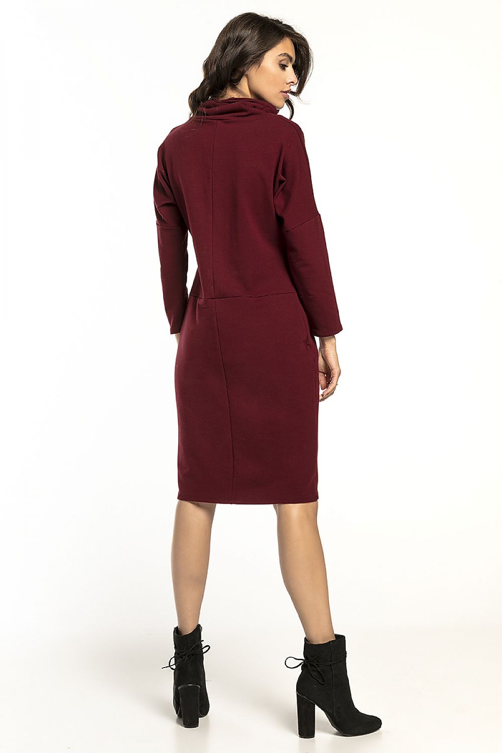 Rear view of Tessita luxurious long-sleeved turtleneck daydress in soft knit, elegantly draped on a model, highlighting the sophisticated design and fit for stylish casual wear.