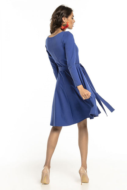 Back view of the Tessita elegant knit dress with long sleeves and an attached belt, showcasing its stylish flared design.