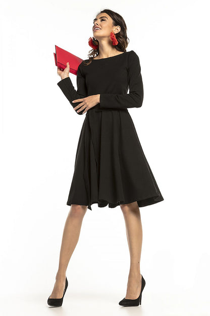 Sophisticated black Tessita knit dress with long sleeves and a stylish belt, perfect for formal events or casual gatherings.