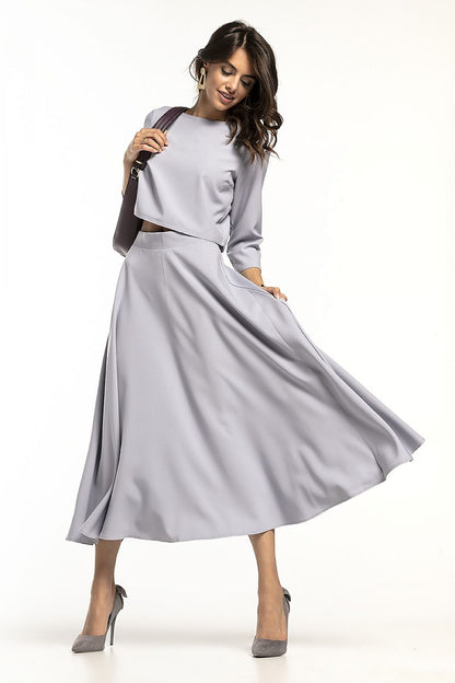 Stylish grey waist-length blouse with 3/4 sleeves, elegantly paired with a flowing skirt, perfect for sophisticated occasions, by Tessita.