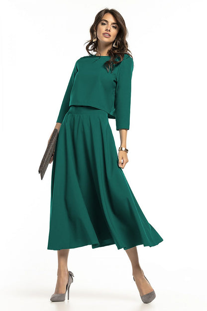 Elegant Tessita waist-length blouse featuring 3/4 sleeves, styled with a flowing skirt in a rich teal colour, perfect for sophisticated occasions.