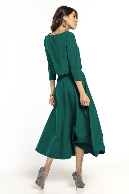 Back view of an elegant Tessita waist-length blouse with 3/4 sleeves paired with a matching flowing skirt in a luxurious teal shade, showcasing a refined silhouette.