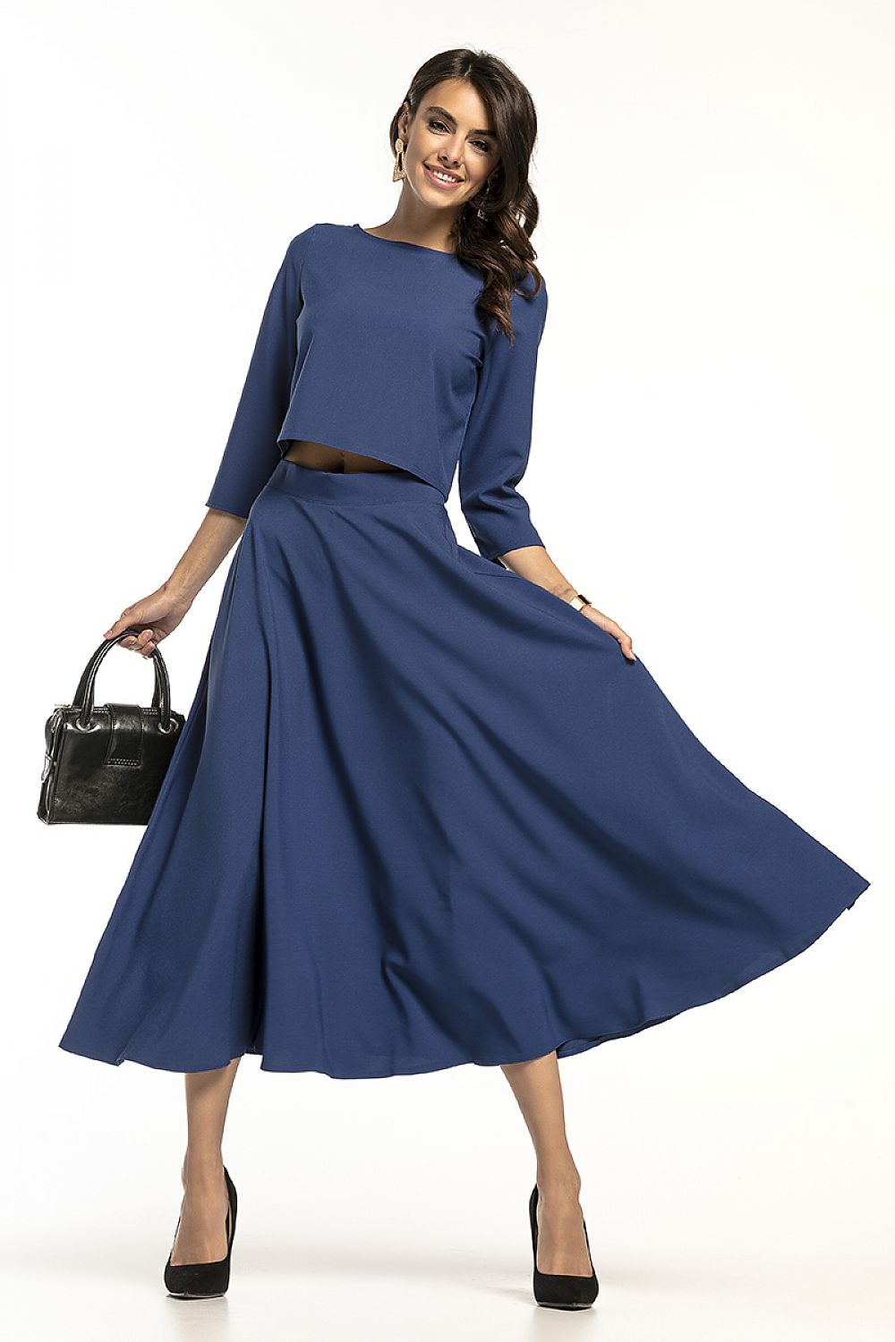 Glamorous Tessita waist-length blouse with 3/4 sleeves, teamed with a striking blue skirt, radiating sophistication and style for luxurious events.
