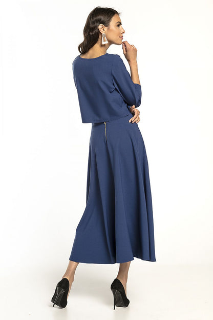 Elegant Tessita waist-length blouse with 3/4 sleeves, showcased in a stunning deep blue outfit, perfect for both casual and formal occasions.