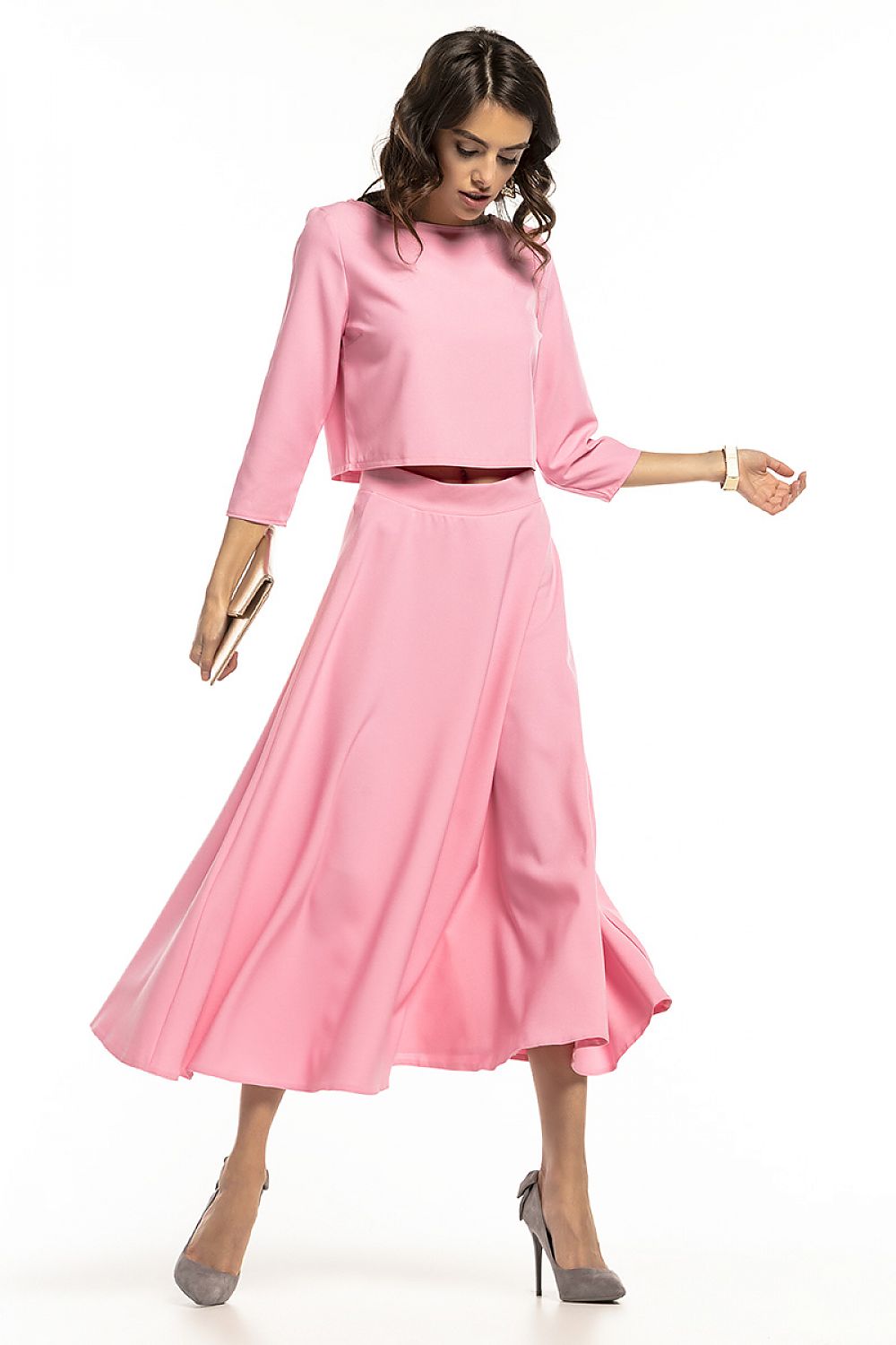 Fashionable Tessita waist-length blouse in vibrant pink, artfully worn with a matching skirt, perfect for a stylish day out.