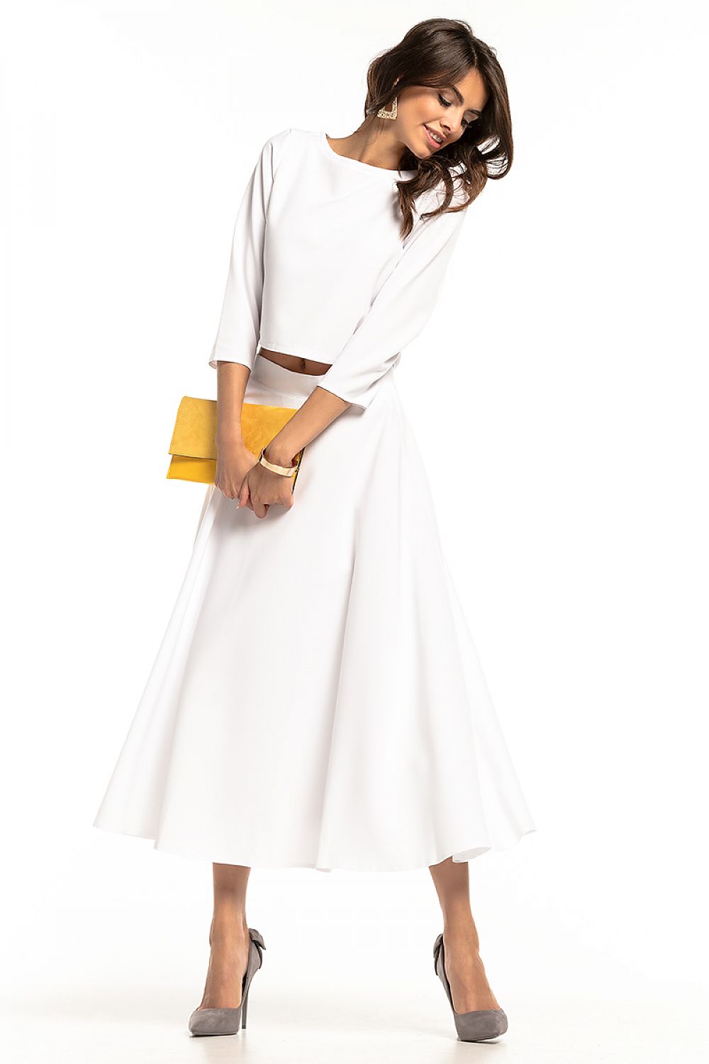 Elegant Tessita waist-length blouse featuring 3/4 sleeves and a half-round neckline, styled with a flowy white skirt, exuding luxury and sophistication.