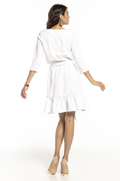 Back view of a refined white daydress with decorative frill and a stylish belt, showcasing luxury design from Tessita.