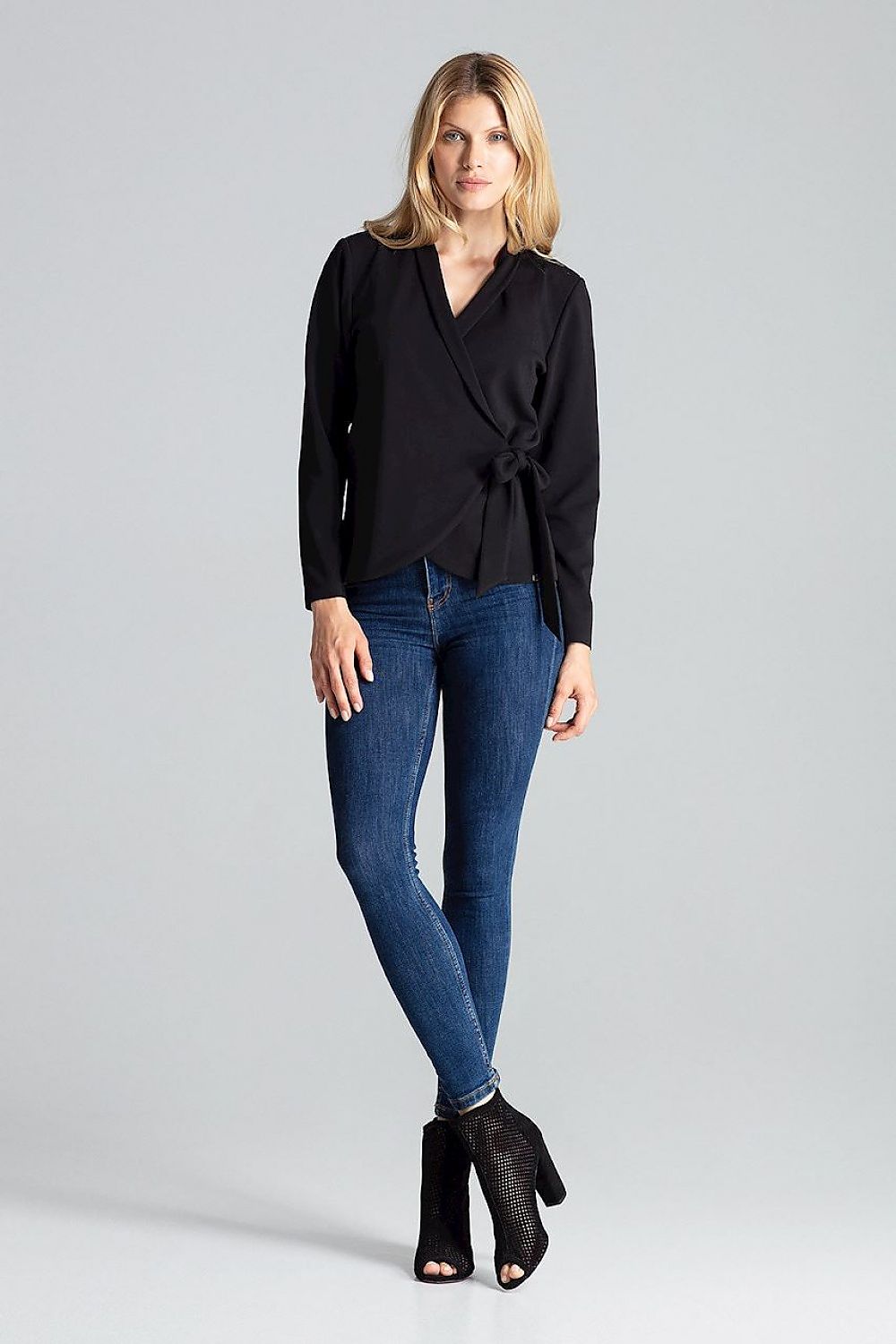 Close-up of the luxurious fabric and design details of the Figl red blouse-jacket with waist tie and cushioned shoulders.