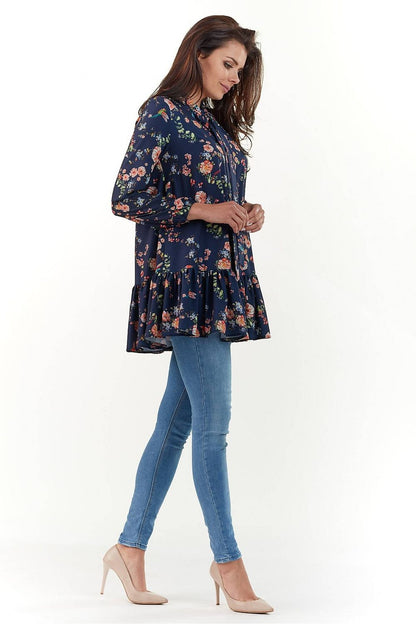 Elegant Long Sleeve Blouse by Infinite You showcased from the side, displaying its luxurious floral pattern and flattering silhouette paired with fitted jeans.