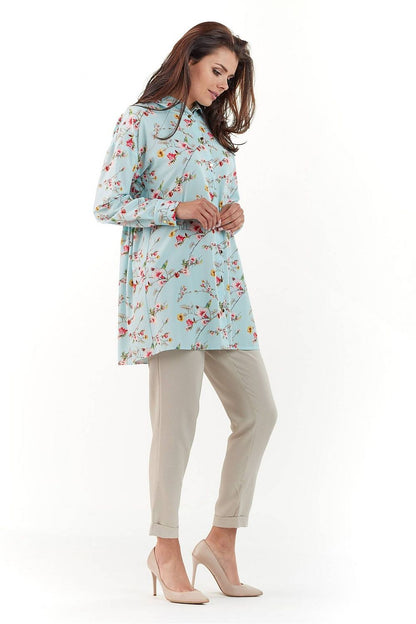 Elegant Long Sleeve Shirt with Charming Crease. A model showcases the beautiful patterned shirt with floral designs in pastel tones, paired with neutral trousers, exuding sophistication.