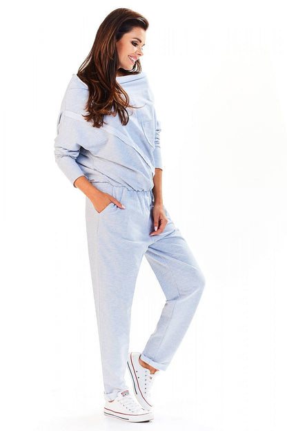 Side view of the Elegant Loose-Fitting Tracksuit With Boat Neckline by Infinite You, featuring a model in a light grey tracksuit, designed for luxury and ease.
