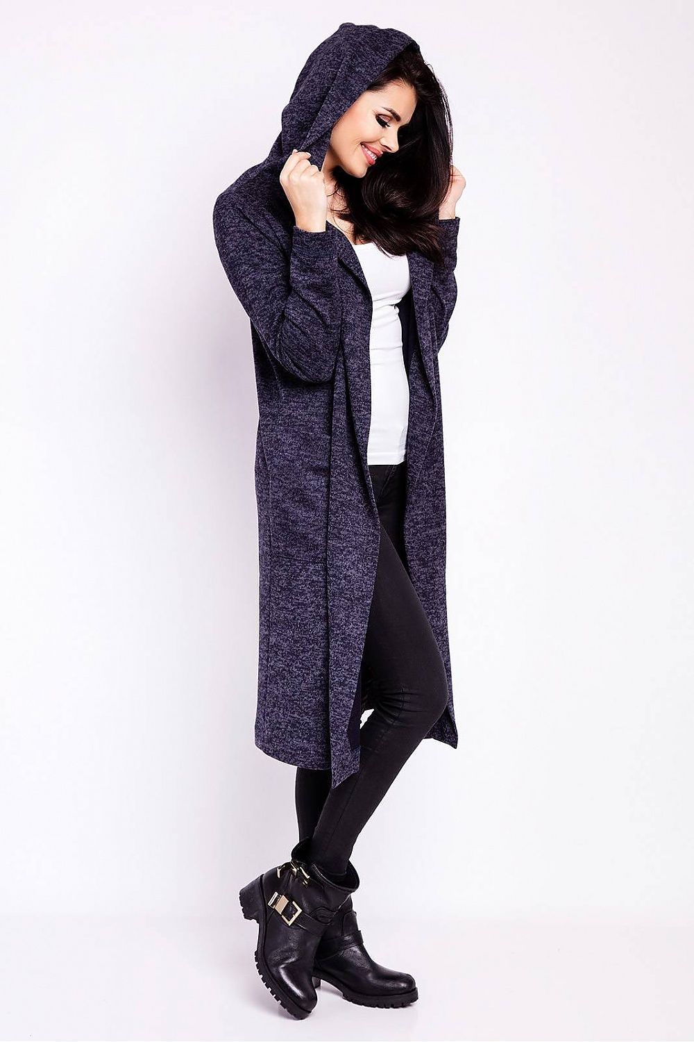 Model wearing the Luxury Long Loose-Fitting Cardigan With Hood and Pockets from Infinite You, featuring a chic, draped look with the hood up, paired with a white top and black leggings.