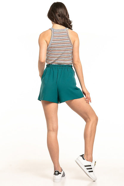 Back view of a model in Tessita Luxury Summer Shorts in teal, designed with a comfortable elastic waistband, paired with a stylish striped tank top, perfect for warm weather.