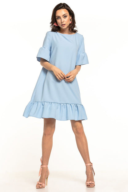 An elegant summer mini dress in soft blue by Tessita, featuring a stylish bow neckline and a frill hem, perfect for chic summer outings. The dress is complemented with delicate short sleeves and can be paired with both sporty shoes and minimalist heels.