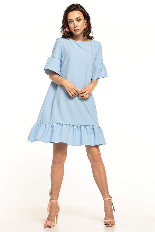 An elegant summer mini dress in soft blue by Tessita, featuring a stylish bow neckline and a frill hem, perfect for chic summer outings. The dress is complemented with delicate short sleeves and can be paired with both sporty shoes and minimalist heels.