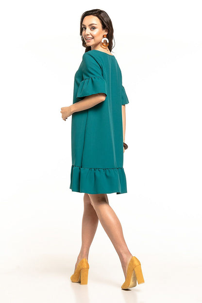 Stylish green summer mini dress showcasing a playful frill hem and flowing silhouette, brought to you by Tessita.
