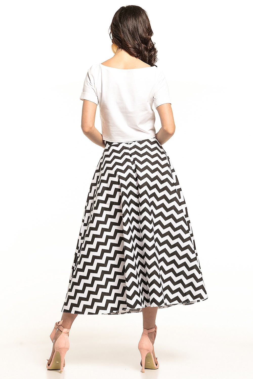 Back view of the chic 1950s-inspired midi skirt by Tessita, showcasing the sophisticated chevron pattern and decorative zip detail, paired with a simple white top.