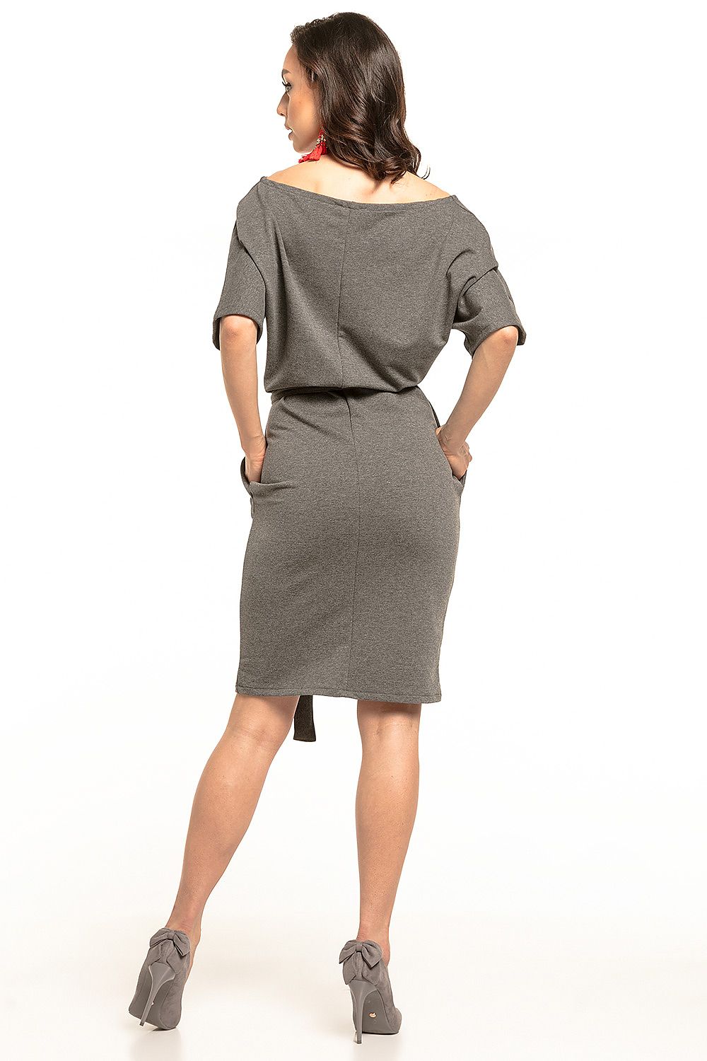 Back view of an elegant grey midi dress by Tessita featuring a relaxed fit with kimono sleeves, styled with a trendy belt and chic grey heels.