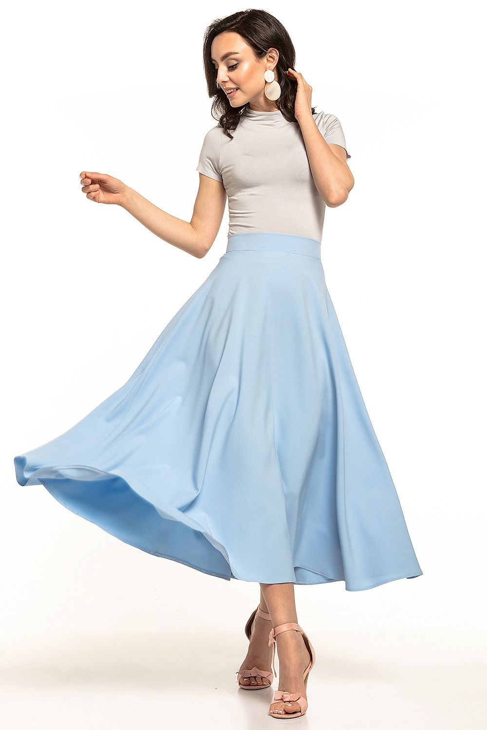 Elegant fifties inspired midi skirt by Tessita, featuring a flowing circle cut design, showcased in light blue fabric, creating a stunning silhouette in motion. Perfect for stylish occasions.