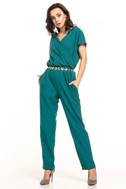 Elegant Tessita jumpsuit in green with short sleeves, gathered waist, and envelope neckline, exuding luxury and style, showcased on a confident model.