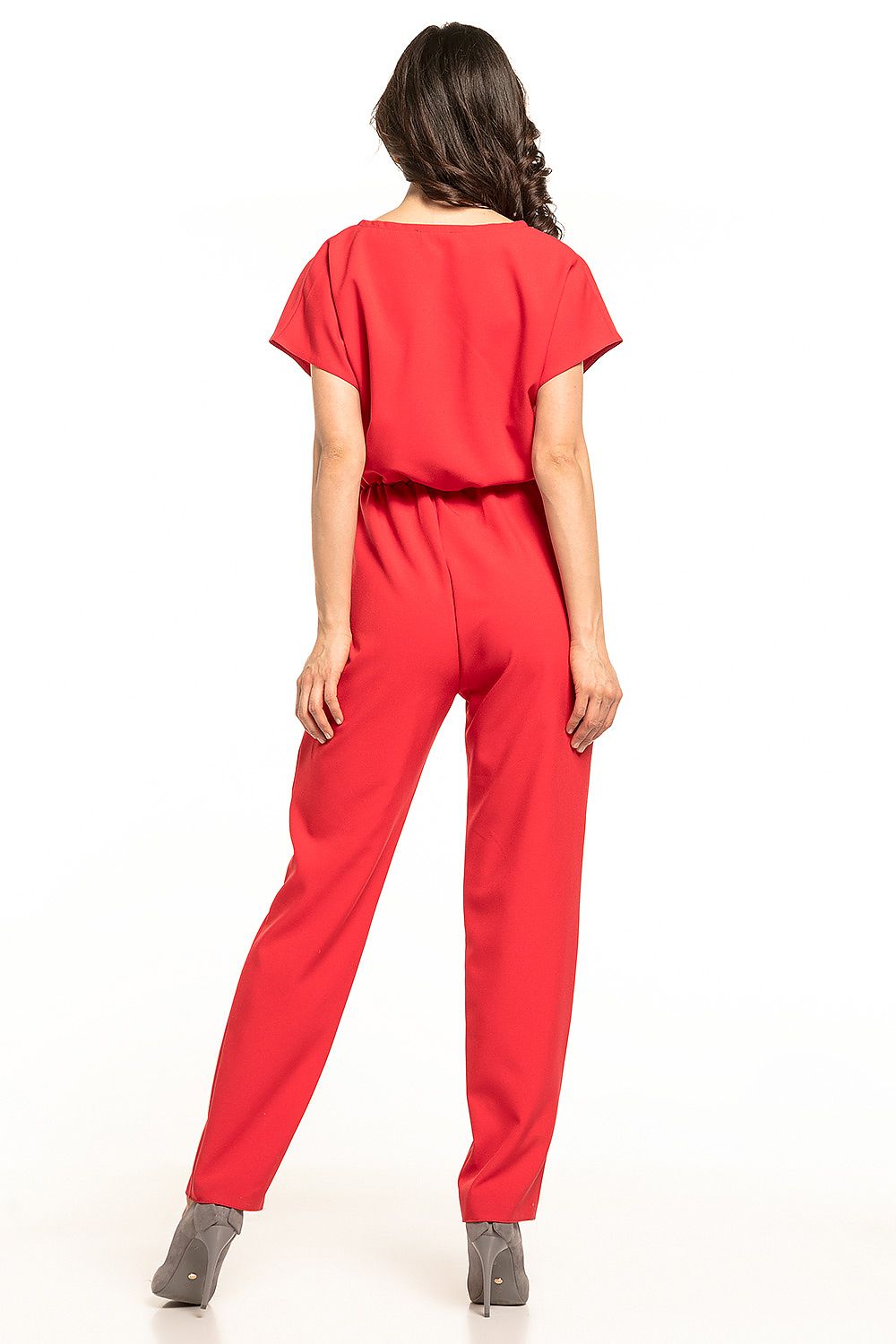 Back view of the striking Tessita red jumpsuit accentuating its graceful silhouette and gathered waist, ideal for upscale occasions.