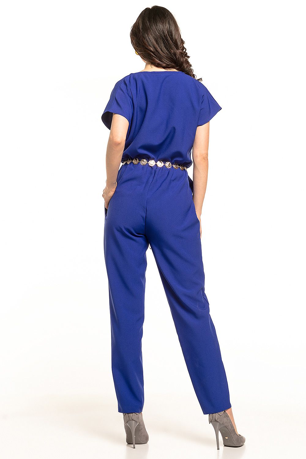 Back view of the elegant Tessita jumpsuit in royal blue, highlighting the gathered waist and sophisticated design. Model exudes style and confidence.