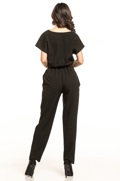 Rear view of the elegant Tessita jumpsuit in black, showcasing the gathered waist and streamlined design. Model captivates with effortless sophistication.