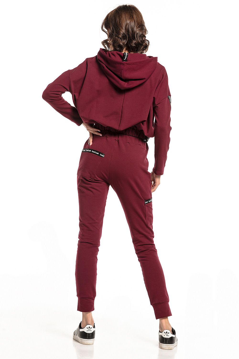 Back view of model wearing Burgundy Luxury Tessita straight-cut tracksuit trousers paired with a cropped hoodie, highlighting the chic design and practical features.