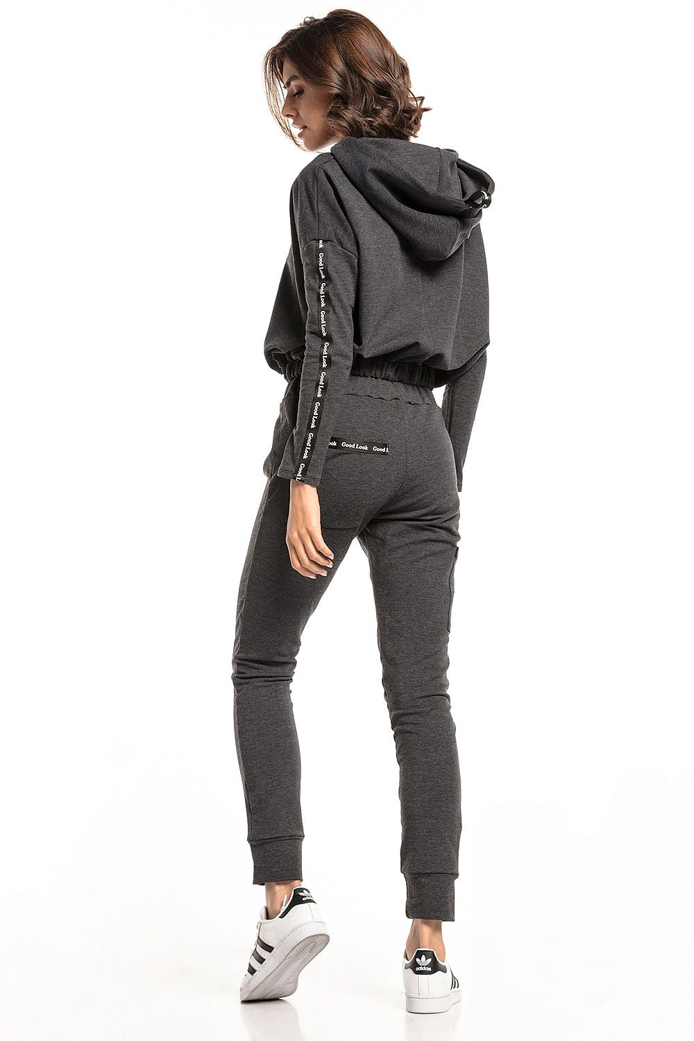Back view of a luxury Tessita straight-cut tracksuit trousers model wearing a stylish cropped hoodie, showcasing the drawstring waist and pockets in a sophisticated dark colour.
