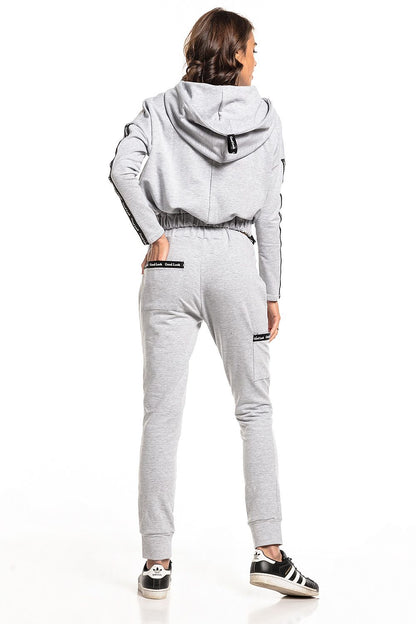 Model showcasing the back of luxury Tessita straight-cut tracksuit trousers paired with a cropped hoodie, designed with a sophisticated fit in a contemporary light grey tone.