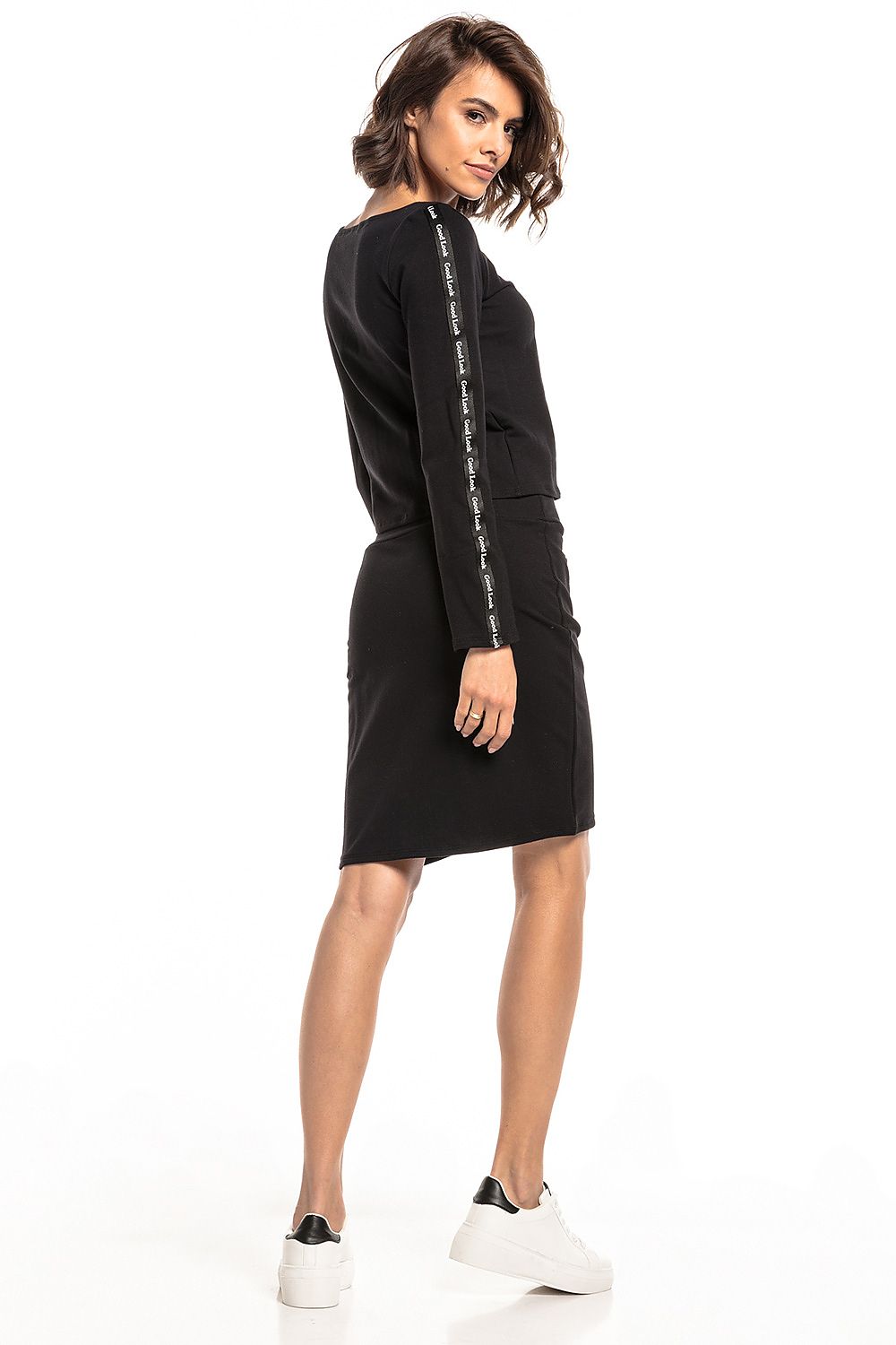 Chic rear view of a luxury black high-waist straight skirt by Tessita, highlighting the sleek design and stylish cropped top.