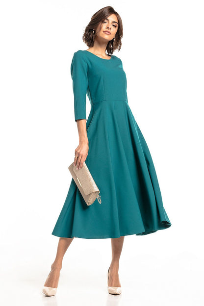 Chic Tessita lightweight maxi dress in teal, accentuated with three-quarter sleeves and a flattering flared skirt, perfect for elegant outings.