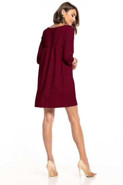 Back view of the Tessita Elegant Pleated Daydress showcasing its pleated design and stylish pockets, exuding elegance for various events.