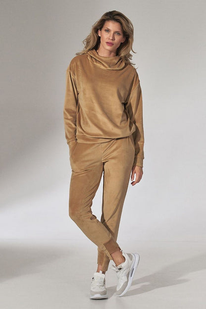 Sophisticated Figl Pink Velour Tracksuit Trousers with Tapered Legs and Drawstring Waist, modelled in a chic pose, exuding a sense of style.