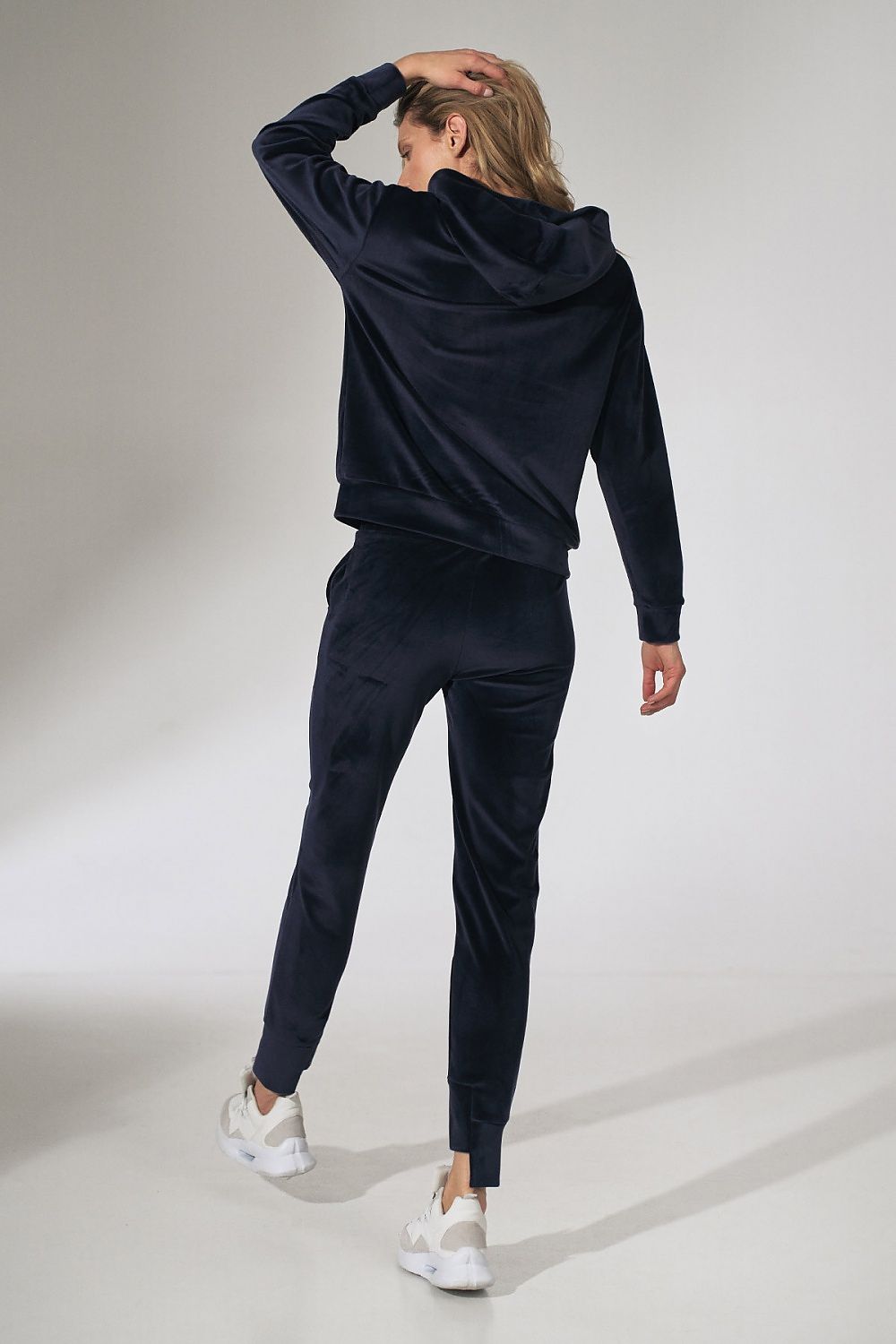 Stylish Figl Pink Velour Tracksuit Trousers with Tapered Legs and Drawstring Waist, displayed from the back, illustrating a blend of modern elegance and casual flair.