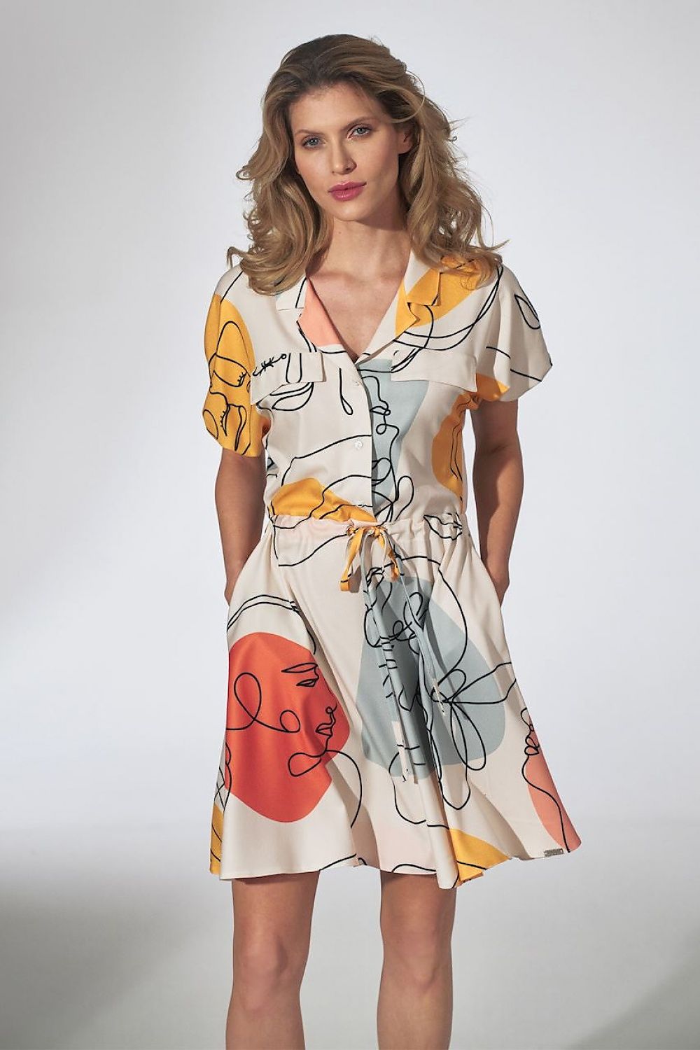 Striking front view of the elegant orange kimono mini dress with collar, flared bottom and side pockets by Figl, featuring vibrant artistic patterns that enhance its chic appeal.
