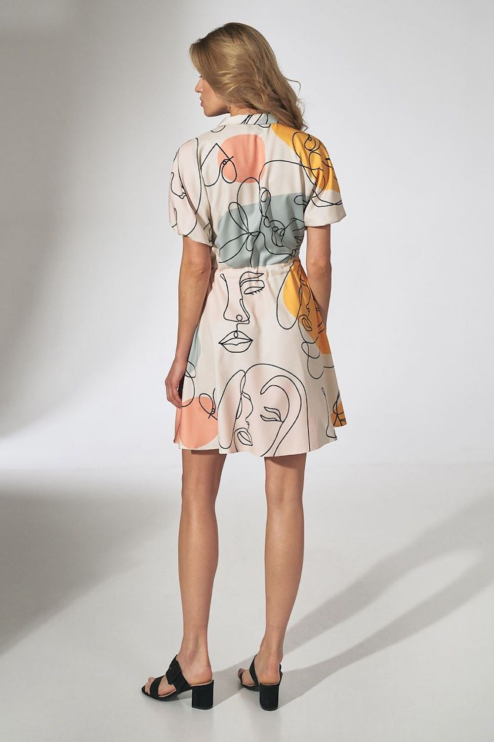 Captivating view from the back of the orange kimono mini dress with collar, flared bottom and side pockets by Figl, demonstrating its elegant cut and luxurious fabric.