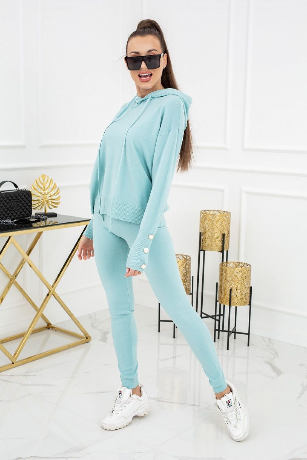 Vittoria Ventini Kim Peral Buttons Two-Piece Leggings Set - Elegant Comfort. A vibrant mint version of the set displayed by a model, highlighting its fashionable design.