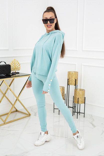 Vittoria Ventini Kim Peral Buttons Two-Piece Leggings Set - Elegant Comfort. A vibrant mint version of the set displayed by a model, highlighting its fashionable design.