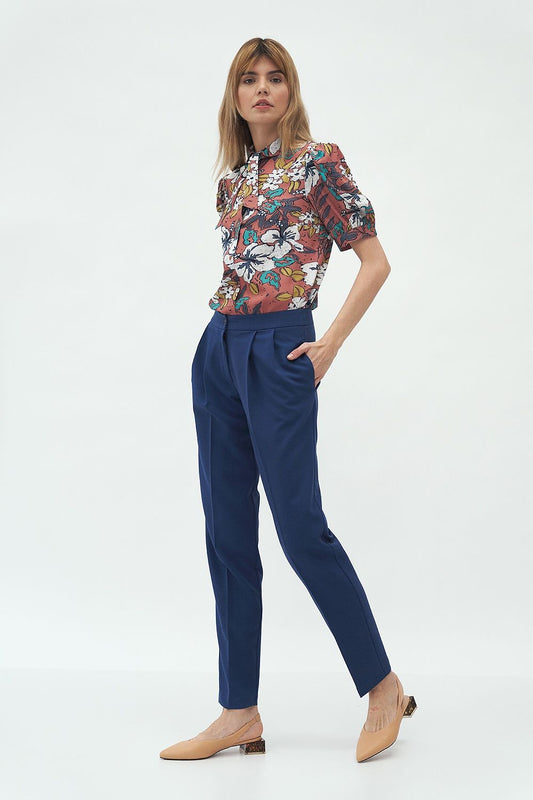 Elegant Stylish Nife Women's Trousers with Pockets showcased in a relaxed office look, featuring a comfortable fit and a floral blouse, perfect for sophisticated styling.