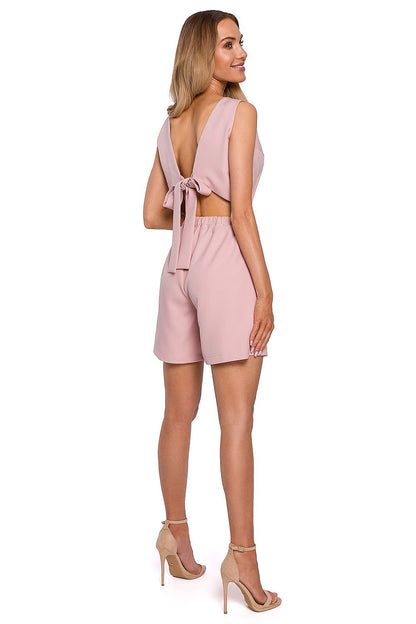 Elegant Open Back Jumpsuit Romper With Tie by Moe, featuring a stunning open back with a delicate tie detail. The model presents a side view, accentuating the playful and modern silhouette ideal for summertime elegance.
