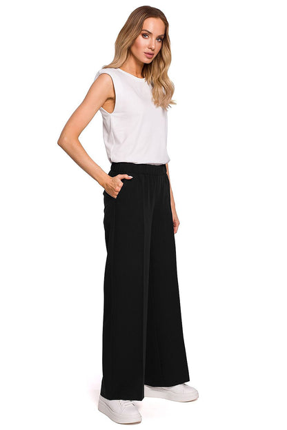 Front view of Elegant Wide Leg Trousers with Pleats and Elastic Waistband by Moe, featuring a model in black, exuding sophistication and comfort.