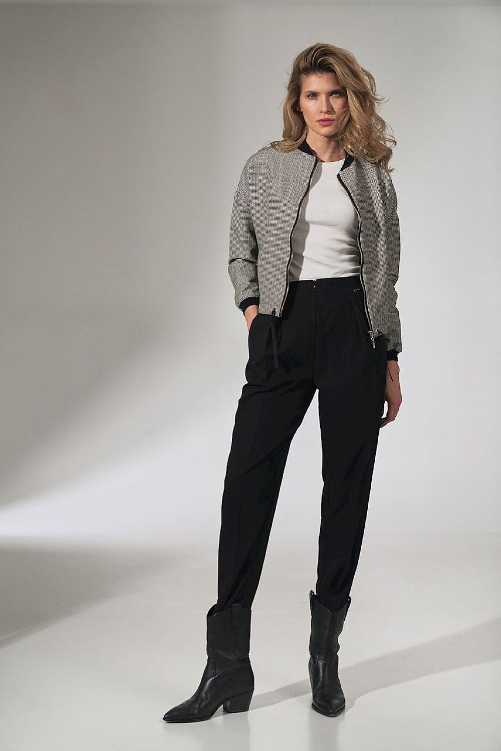 A sophisticated image of a model in the Stylish Checked Bomber Jacket by Figl, highlighting its versatile design with a zip fastening and chic ribbed details, paired with tailored trousers.