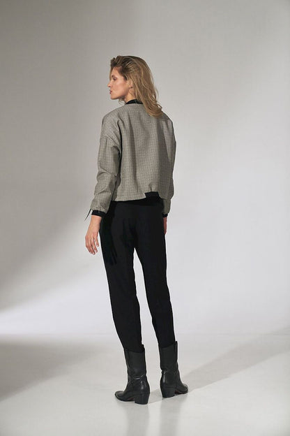 A stylish rear view of a model wearing the Stylish Checked Bomber Jacket by Figl, displaying its exquisite craftsmanship and modern silhouette, completed with fashionable ankle boots.