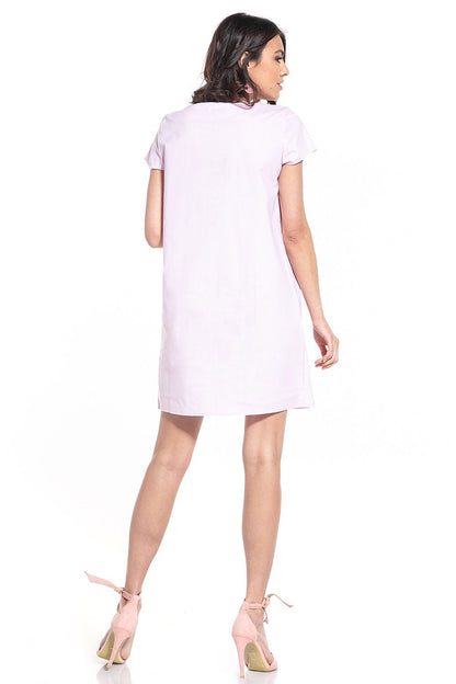 Side view showcasing the elegant silhouette and short sleeves of the Tessita cotton mini dress for a luxe summer look.