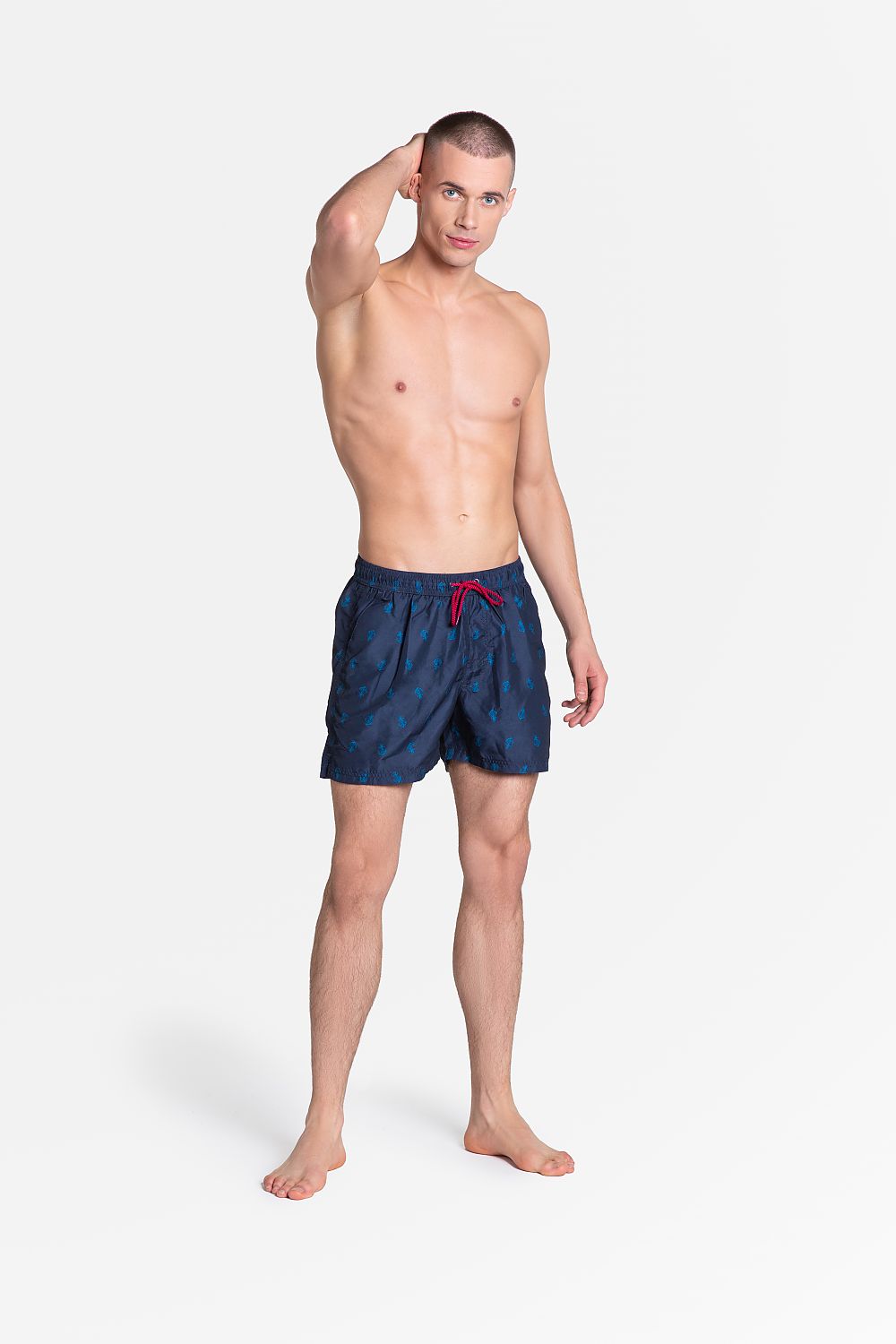 Henderson Men's Quick-Drying Swim Trunks with Navy Pattern, Pockets & Lining on a model, exhibiting elegant navy colour and functional pockets, perfect for summer activities.
